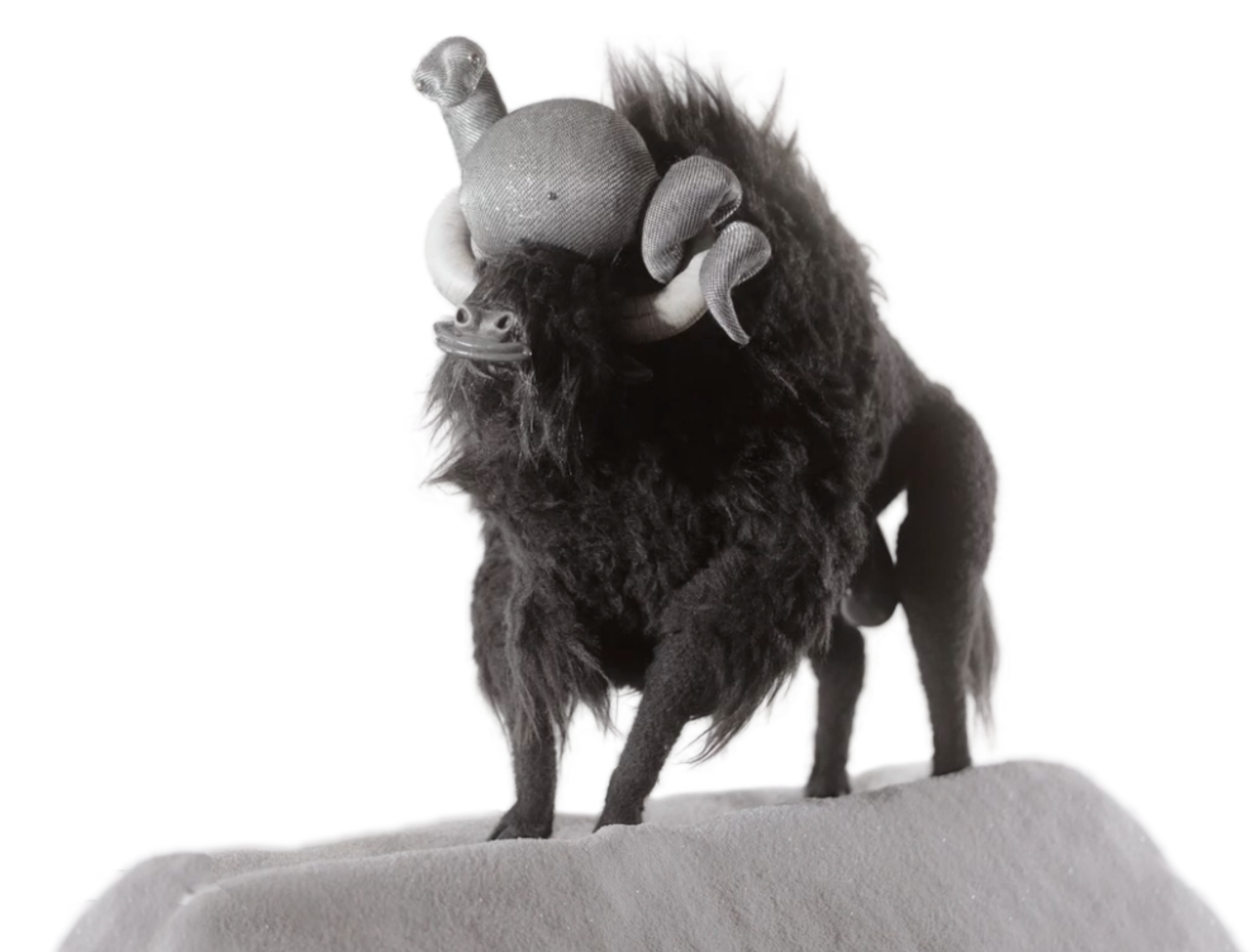 A handmade black buffalo puppet standing on a plinth — meet the OmuO team
