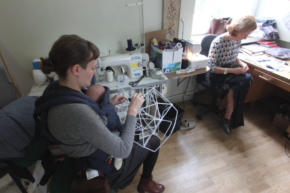Artists crafting puppets and sculptures in the workshop